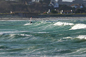 Windsurfer on Vazon on a chilly, grey, and stormy afternoon